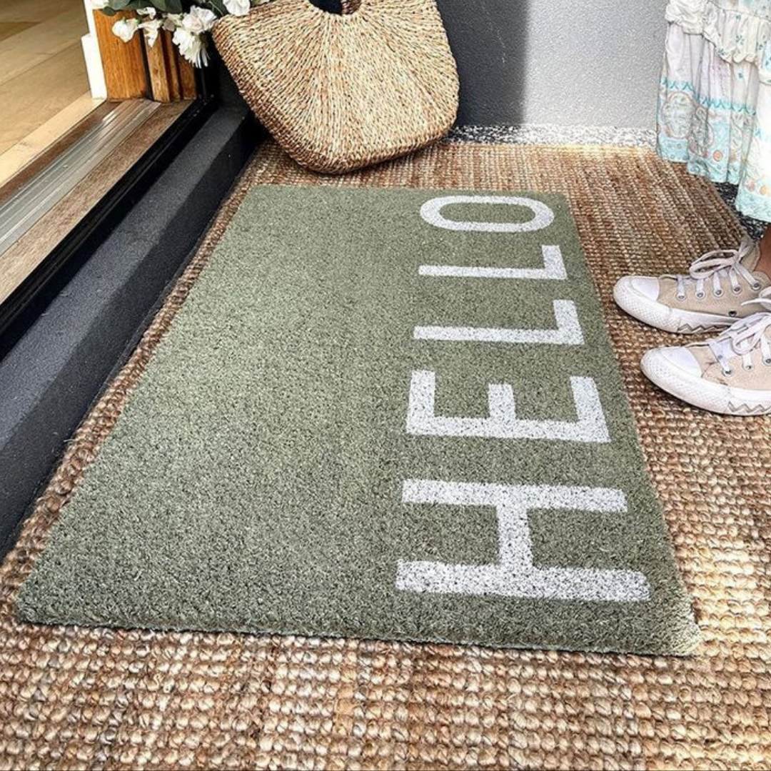 A doormat with a friendly "hello" greeting guests at the entrance.