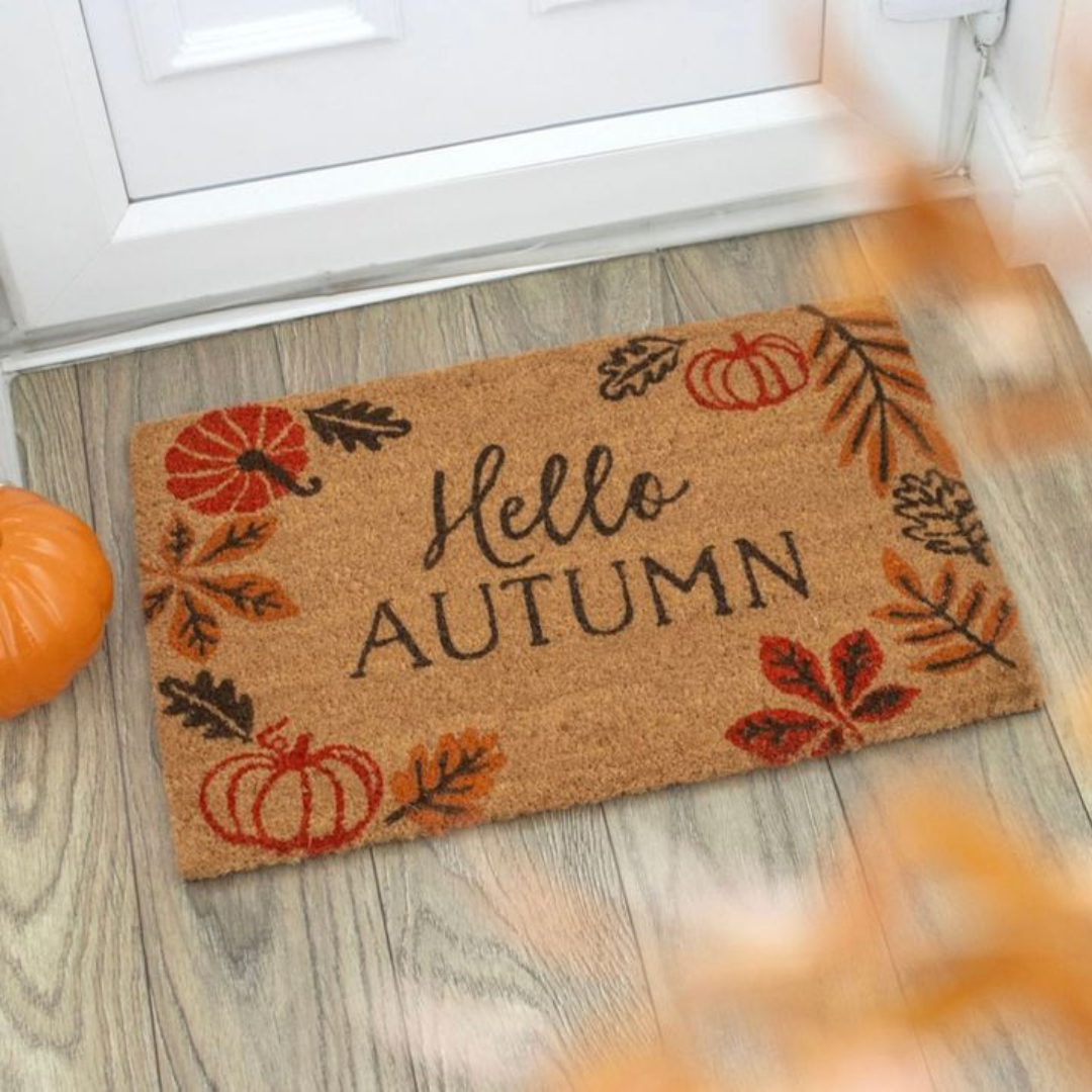 A vibrant doormat with "Hello Autumn" text, showcasing fall colors and a welcoming vibe for the season.