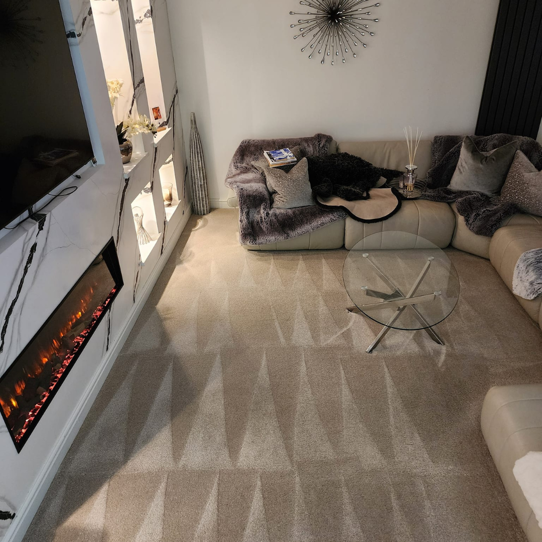 Inviting living room with a stylish couch and a glowing fireplace, creating a warm and welcoming atmosphere.