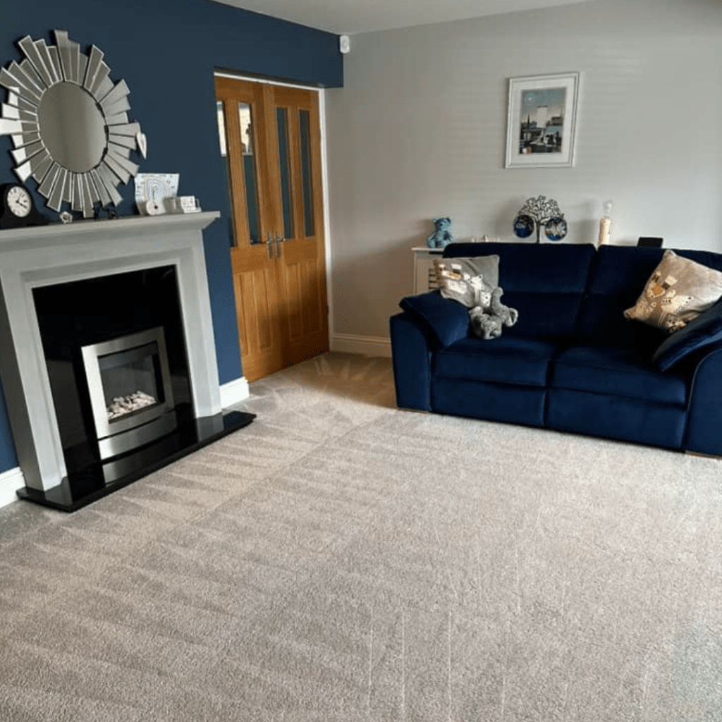 Bright living room with soothing blue walls and a charming fireplace, creating a welcoming atmosphere for gatherings.