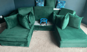 A green couch, creating a cosy and inviting seating area.
