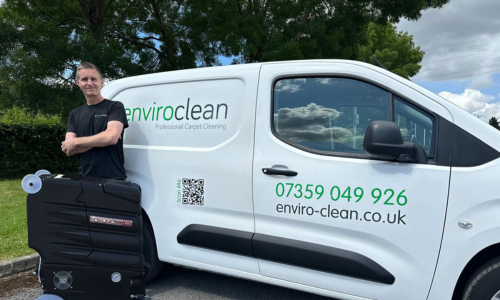 Mark Stevens from Enviro Clean using professional carpet cleaning equipment in a customer’s home.