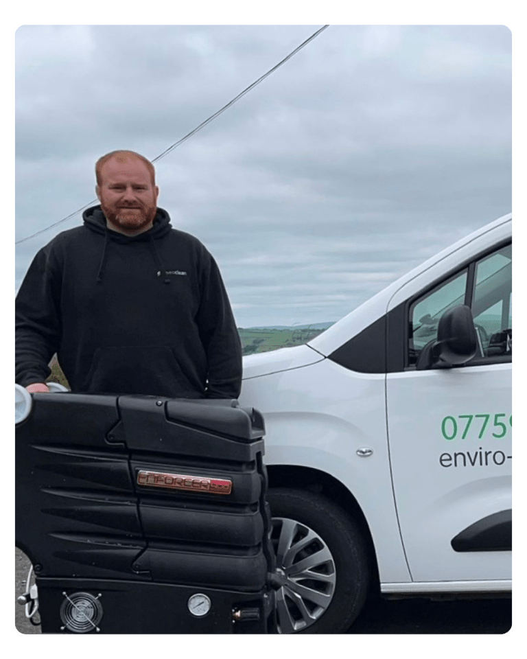 Andrew (man) with enviro clean uniform on, standing outside, infront of branded enviro clean clean with his carpet cleaning materials.