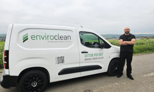 approachable professional carpet cleaner infront of sceneic area, with a white van sign written enviro clean carpet and upholstery cleaning barnsley.